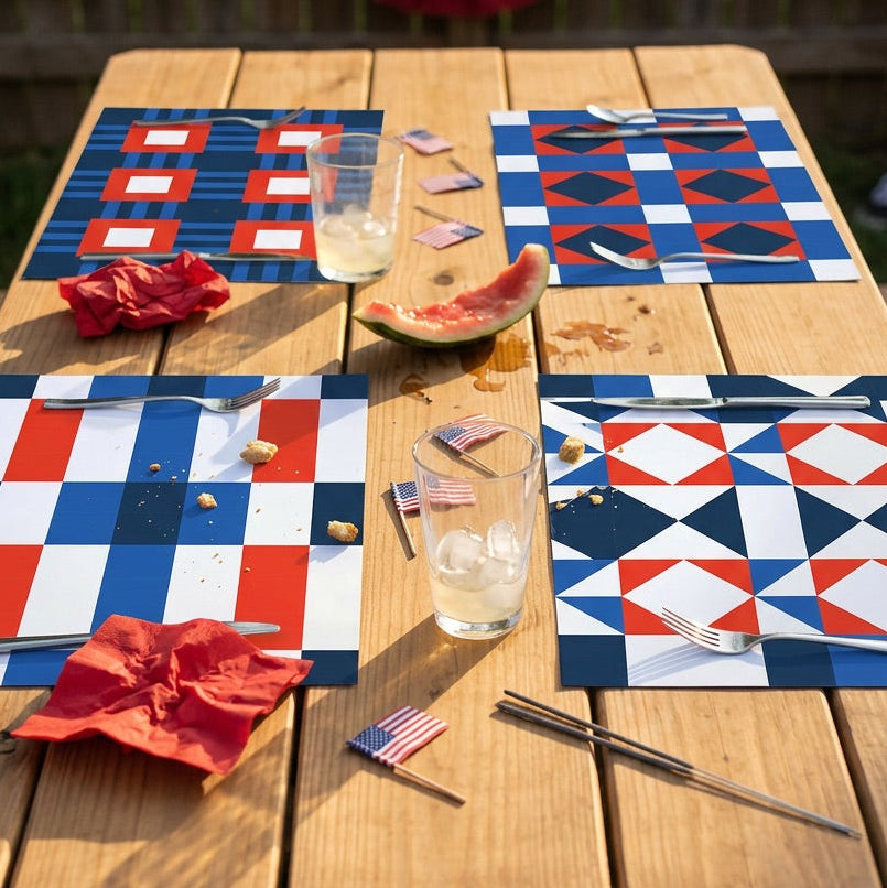 Outdoor table setting with red, white, and blue quilt design paper placemats and American flags.