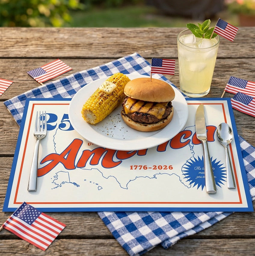 Outdoor setting with a plate of food, drink, and American flags on a patriotic paper placemat.