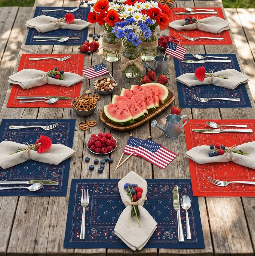 Outdoor table setting with American flags, red, white, and blue decor, and food on a wooden table.