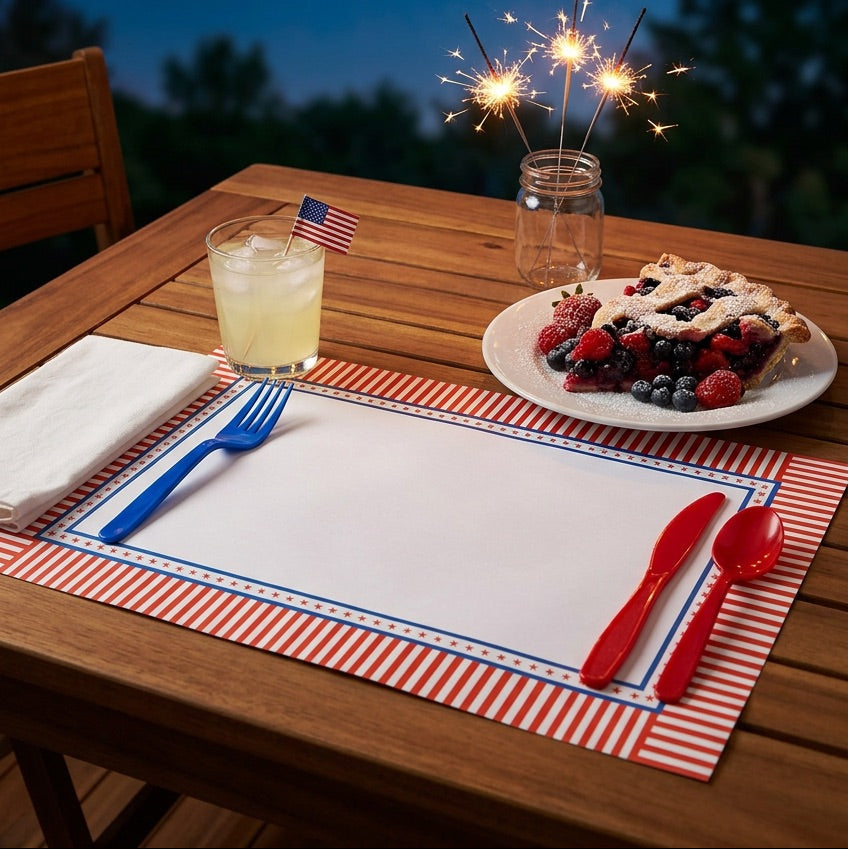 Outdoor table setting with pie, drinks, and sparklers against a night sky with fireworks.