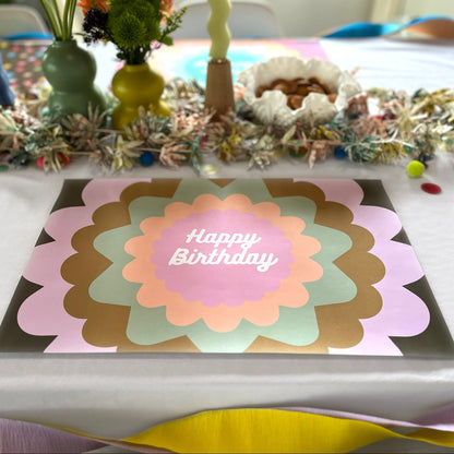 Decorative birthday paper placemat on a table with party decorations