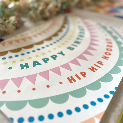 Colorful birthday banner with text on a paper placemat.