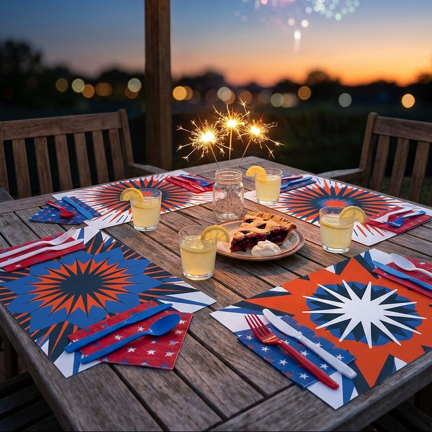 Outdoor table setting with patriotic paper placemats, pie, and lemon slices under a wooden pergola with fireworks in the background.