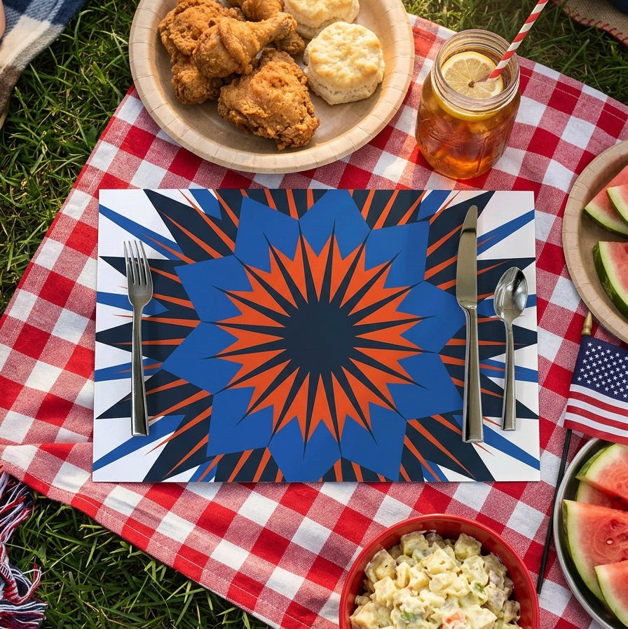 Outdoor picnic setup with fried chicken, biscuits, salad, and watermelon on a red, white and blue patriotic paper placemat.