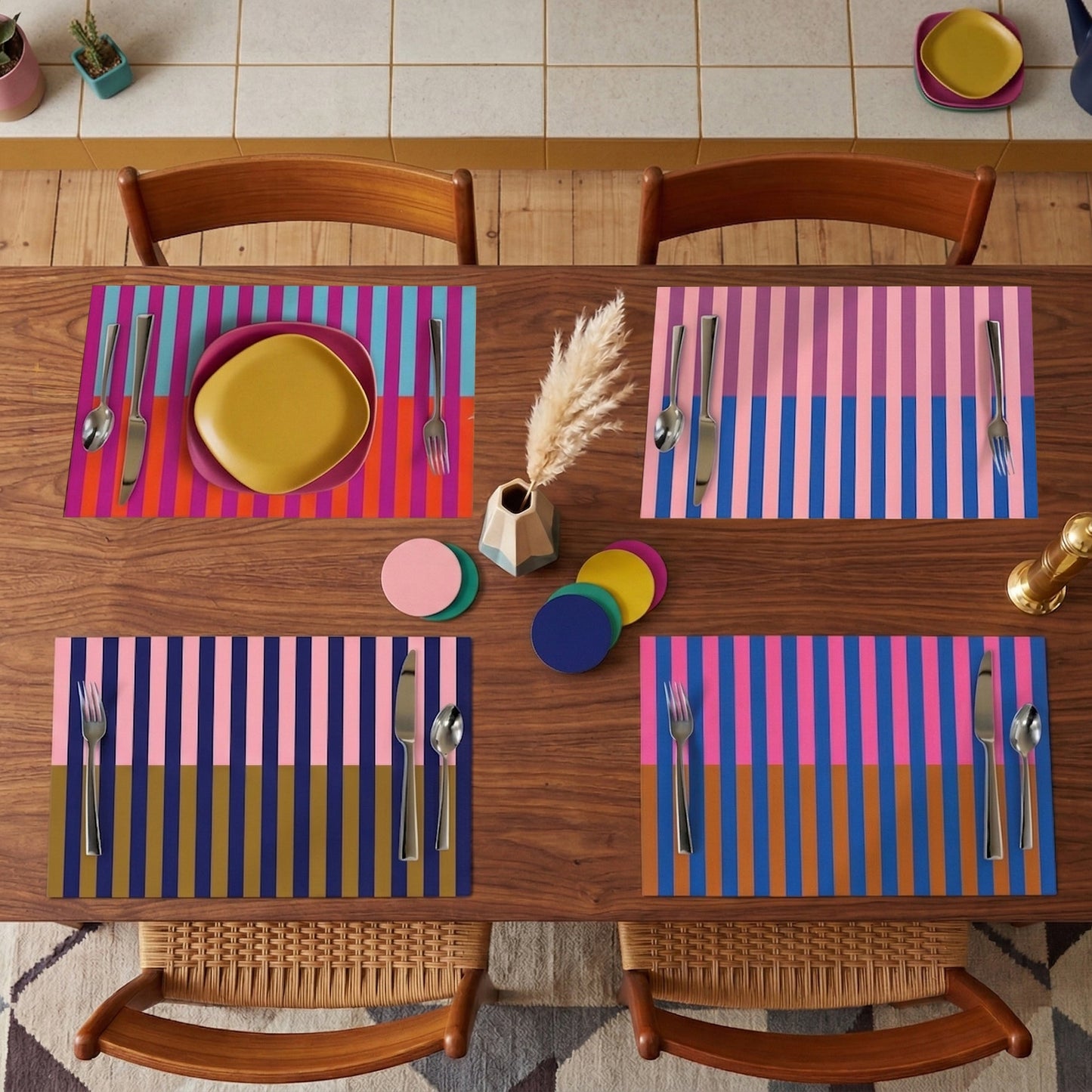 Dining table set with colorful striped paper placemats, plates, and cutlery on a wooden table.
