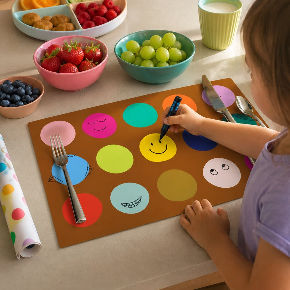 Child coloring on a placemat with a kitchen counter in the background