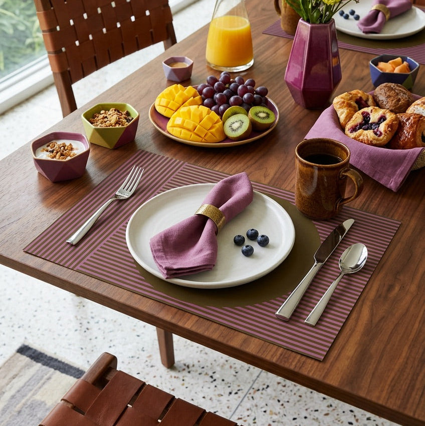 Modern striped paper placemat on a wood table set up for a modern breakfast.