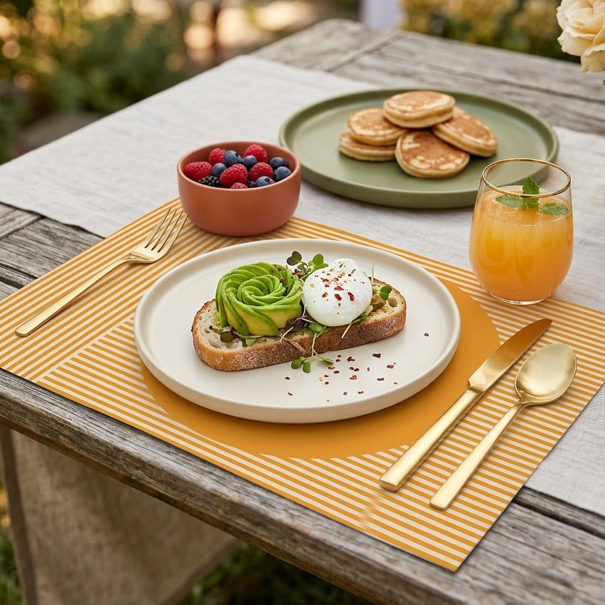 Modern striped paper placemat on a wood table set up for an outdoor brunch. 