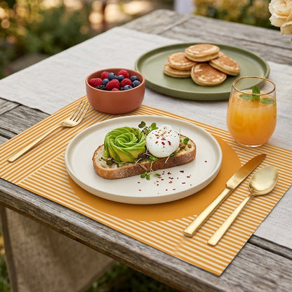 Modern striped paper placemat on a wood table set up for an outdoor brunch. 