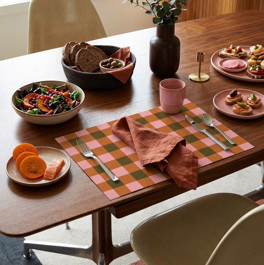 Plaid paper placemat on a modern table set for dinner. 