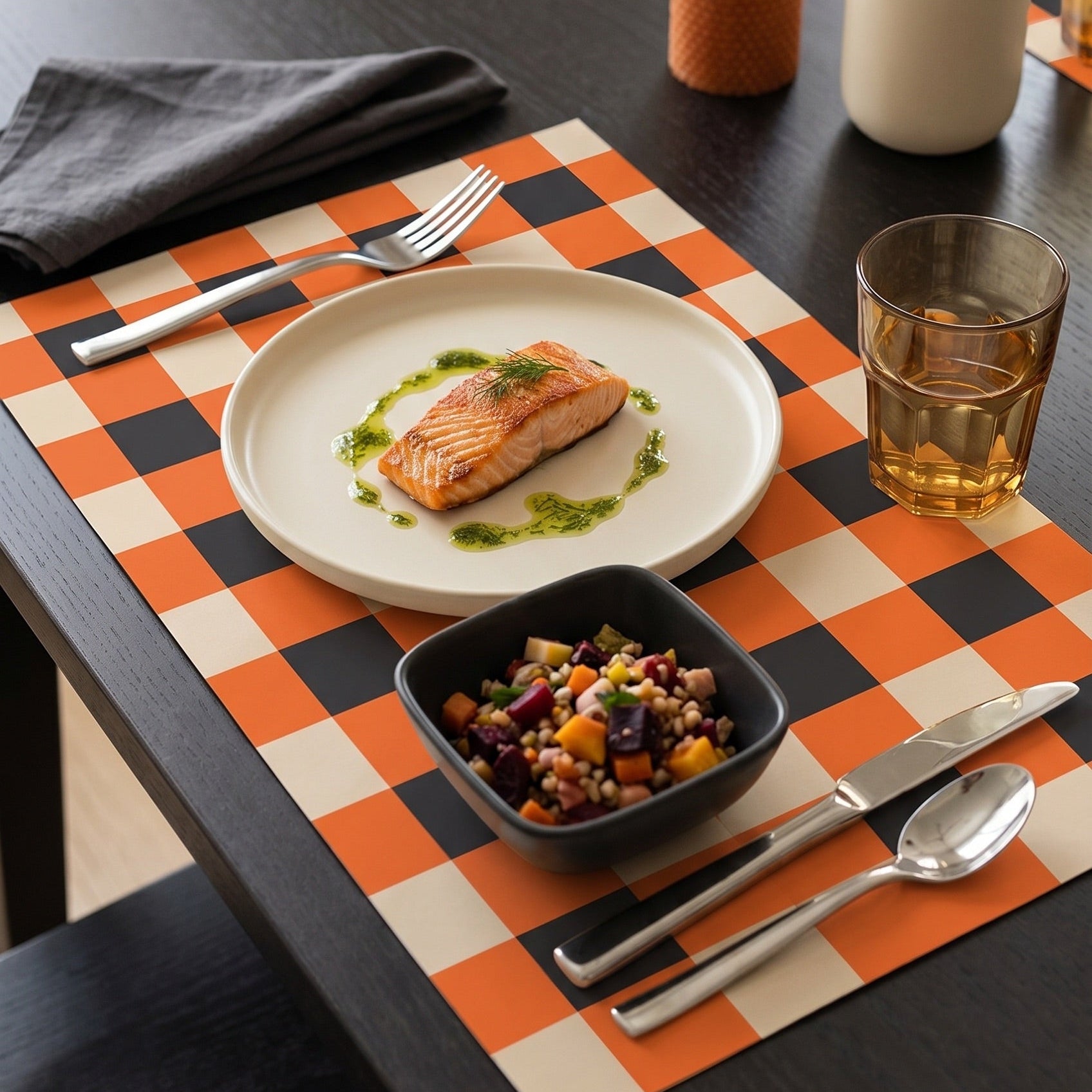 Plaid paper placemat on a modern table set for dinner. 