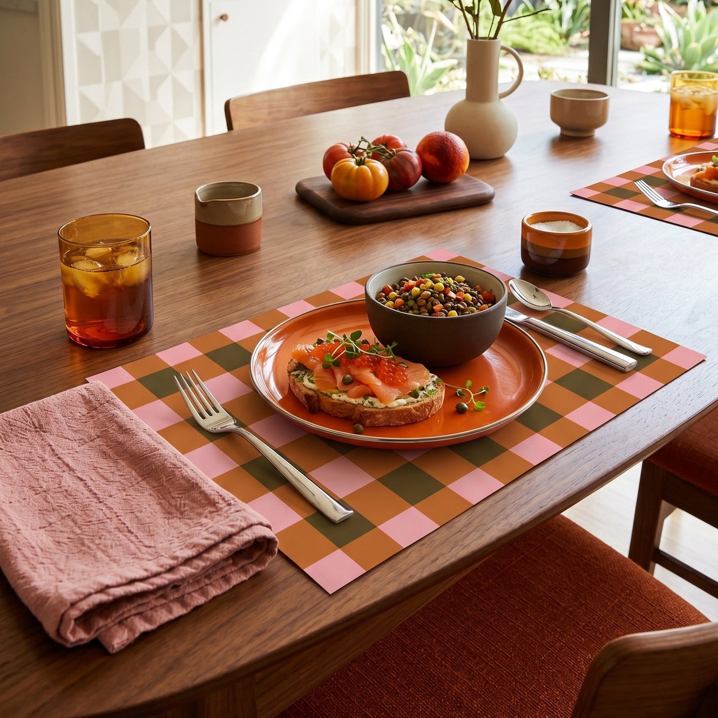 Plaid paper placemat on a modern table set for dinner. 