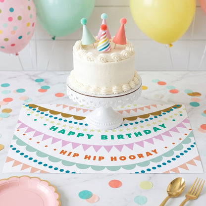 Happy Birthday paper placemat with a birthday cake and balloons. 