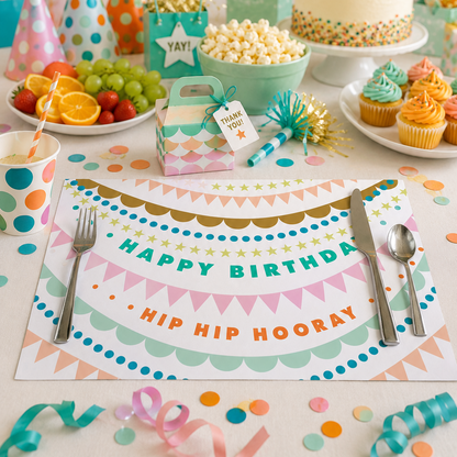 Birthday party setup with cake, balloons, and decorations on a birthday paper placemat.
