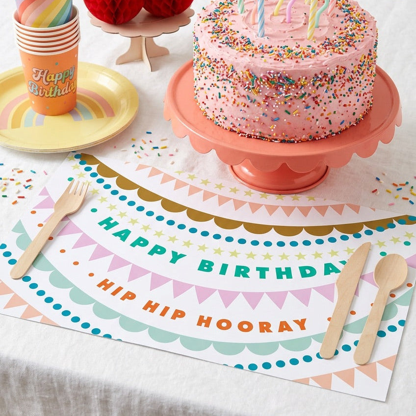 Happy Birthday paper placemat with a birthday cake and balloons. 