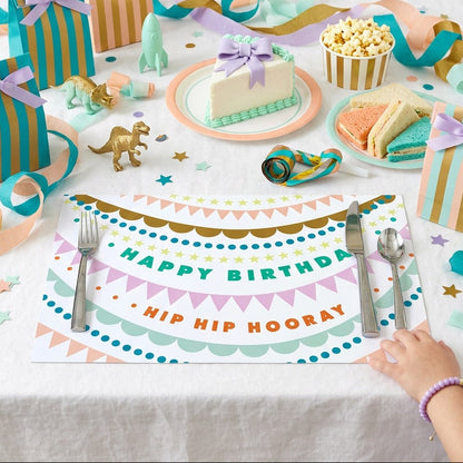 Happy Birthday paper placemat with a birthday cake and balloons. 