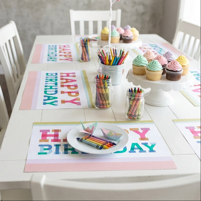 Happy birthday paper placemat on a table with a birthday cake. 