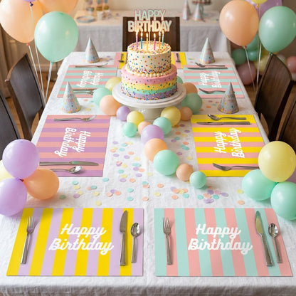 Birthday party paper placemats with colorful balloons, cake, and tableware on a table.