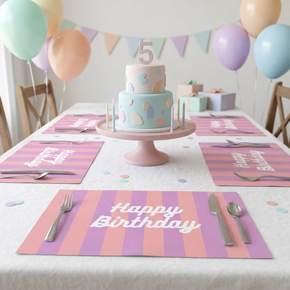 Birthday table setting with a cake, balloons, and 'Happy Birthday' paper placemats.