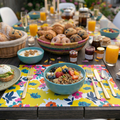 Outdoor breakfast table with bowls of cereal, pastries, and drinks on a colorful paper placemat.