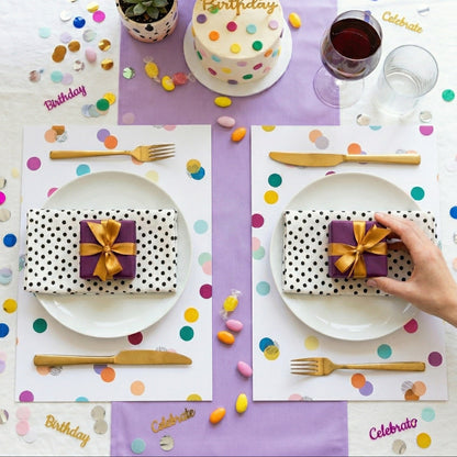 Confetti paper placemats with confetti on the table set for a birthday party. 