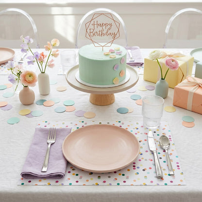 Confetti paper placemat on a table set for a birthday party. 