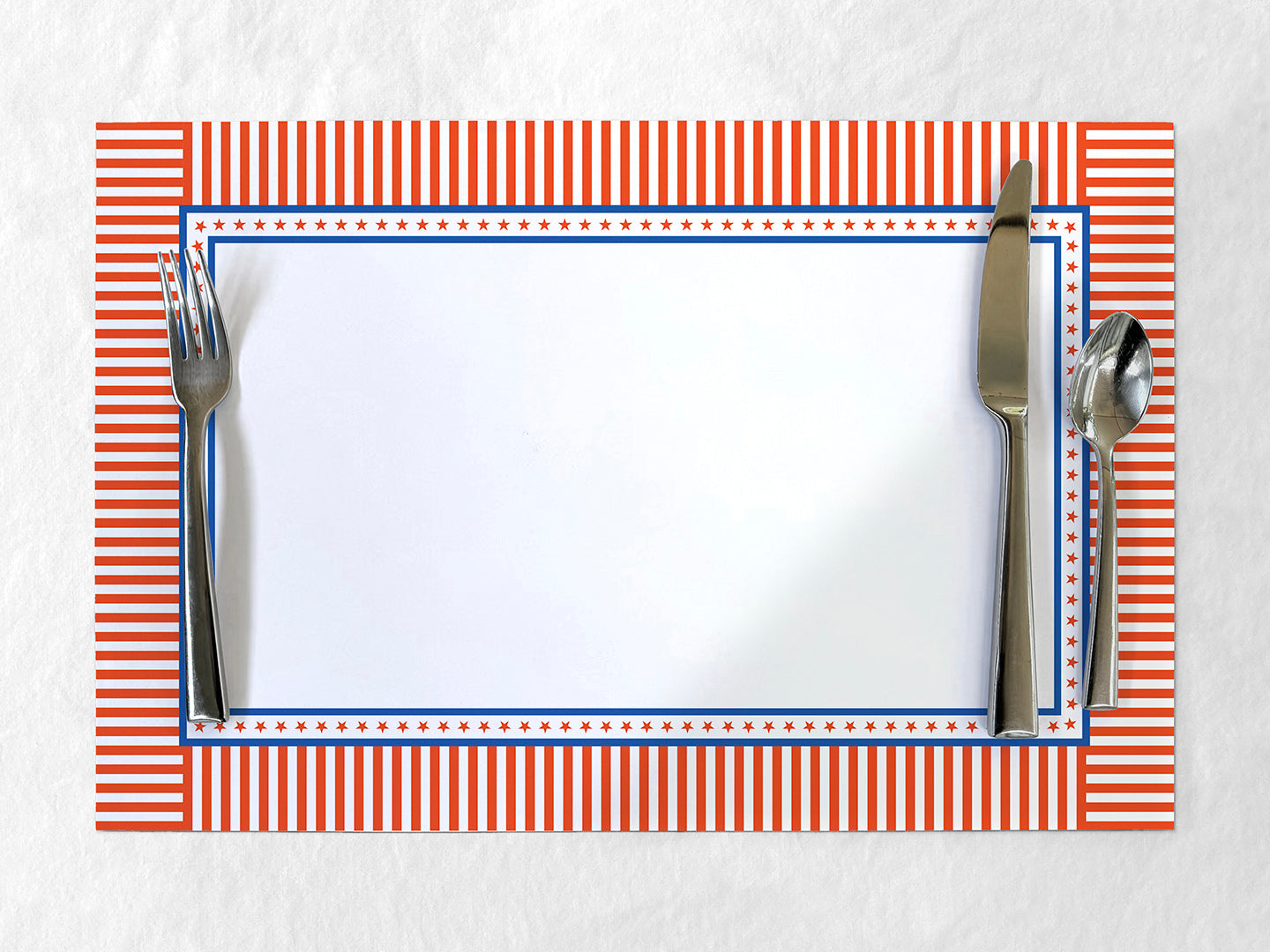 Placemat with red and blue striped border and cutlery on a white background