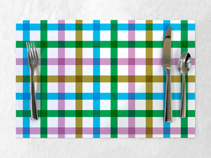 Colorful plaid paper placemat with cutlery on a white background