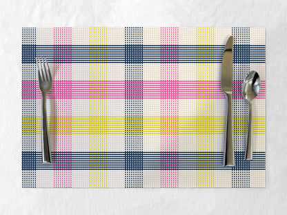Colorful plaid paper placemat with cutlery on a white background