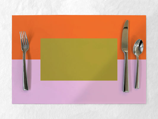 Colorful paper placemat with cutlery on a textured surface