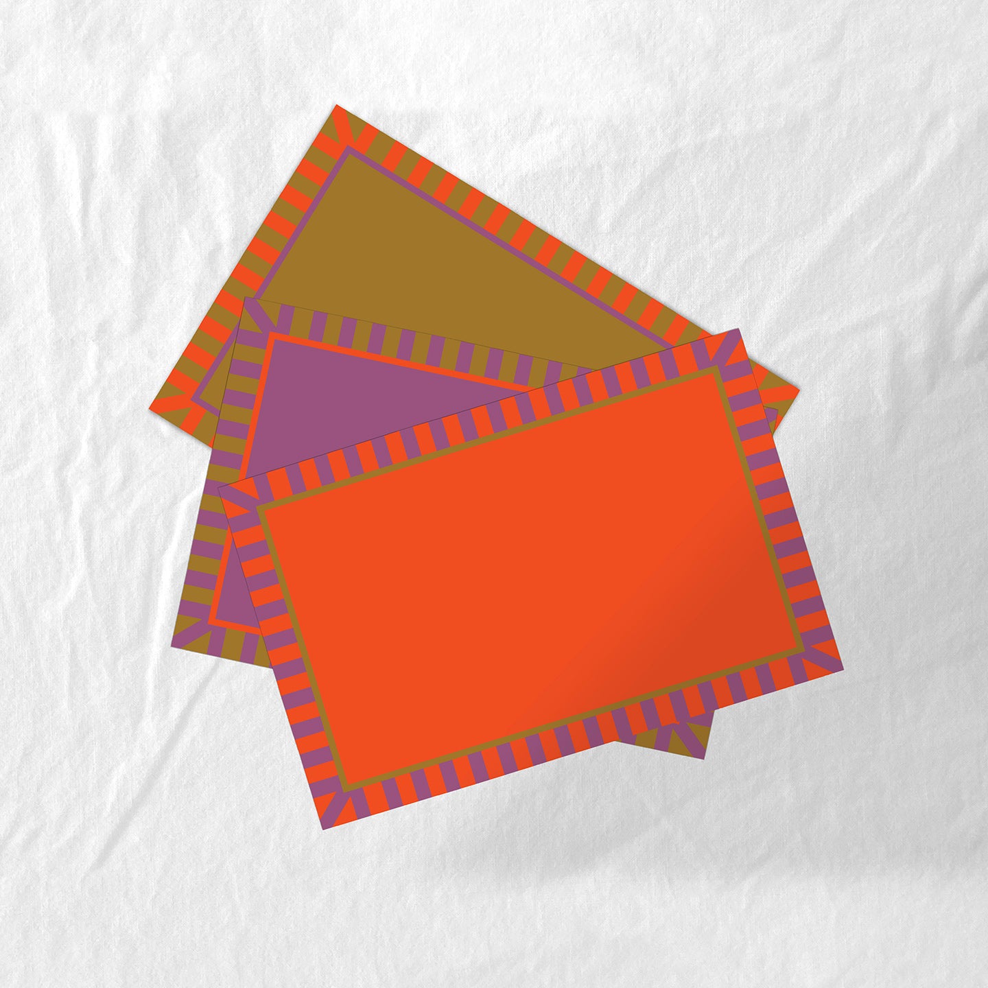 Colorful set of placemats with geometric patterns on a white fabric background