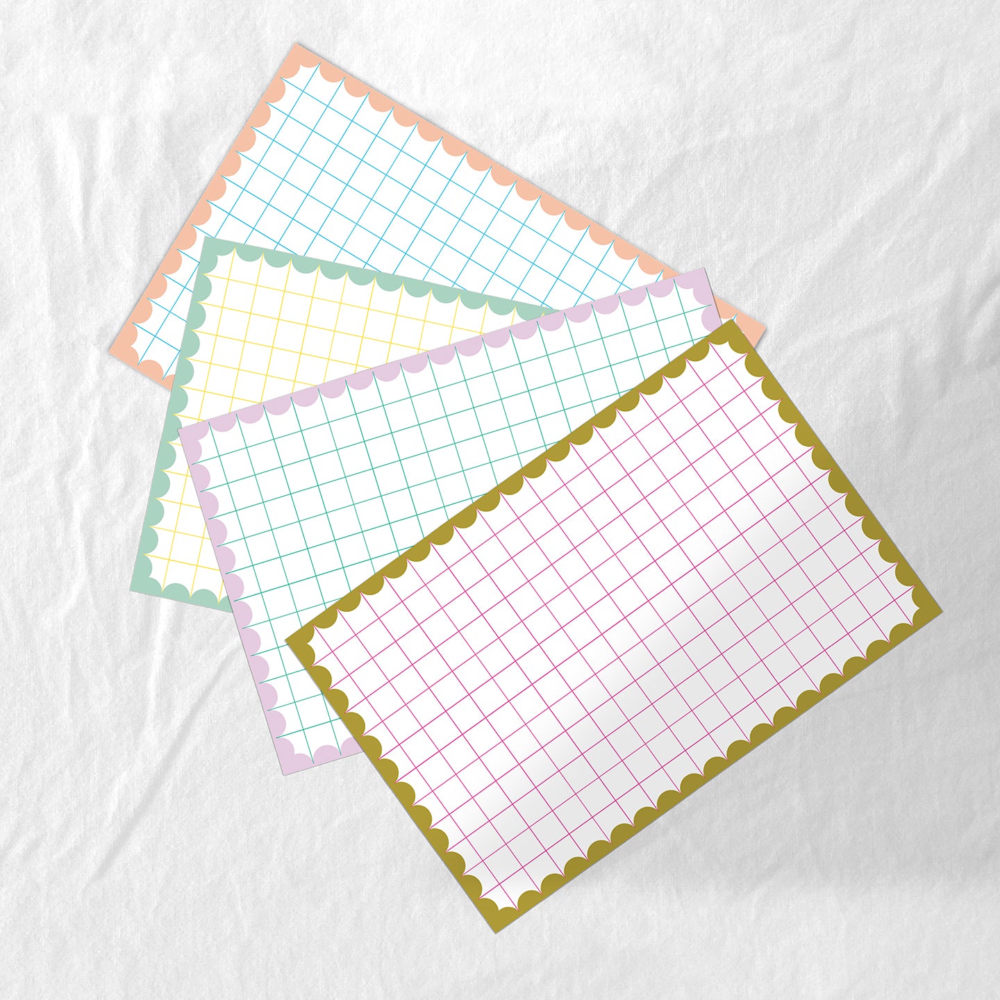 Set of paper placemat with grid pattern and cutlery on a white background