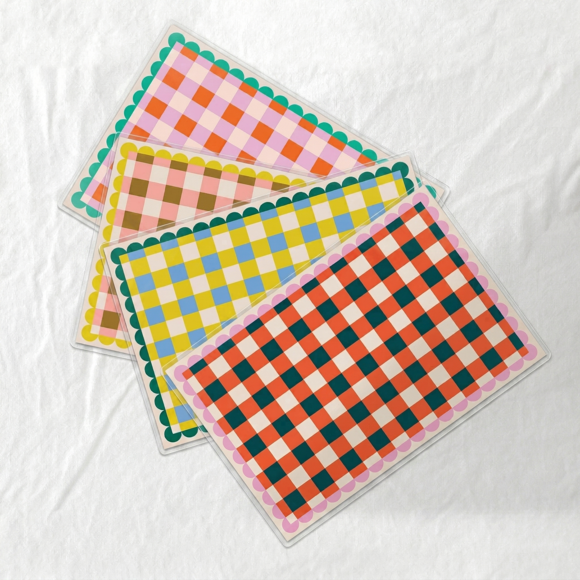 Set of colorful checkered paper laminated placemats on a white background