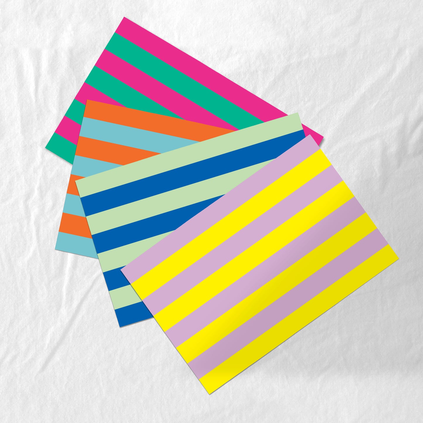 Colorful striped paper placemats on a white background