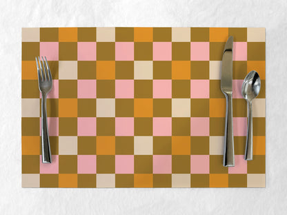 Checkered paper placemat with cutlery on a white background