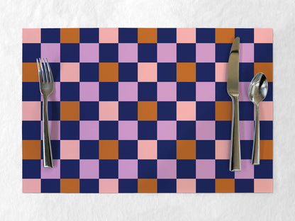 Checkered paper placemat with cutlery on a white background