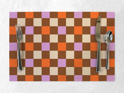 Checkered paper placemat with cutlery on a white background