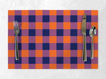 Checkered placemat with purple and orange squares, featuring a fork, knife, and spoon on a white background.