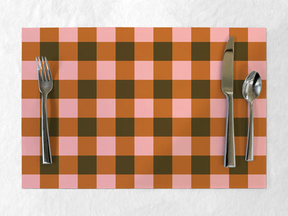 Checkered placemat with cutlery on a white background
