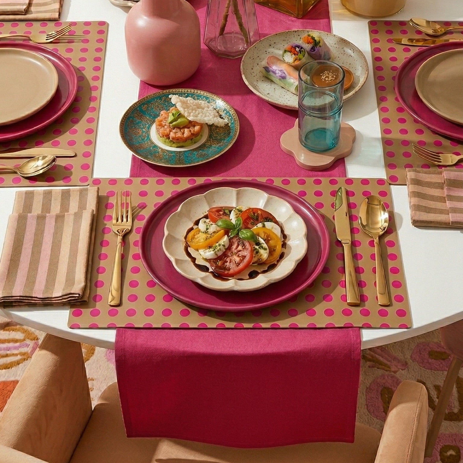 Dining table set with colorful plates, napkins, and paper plaacemats.
