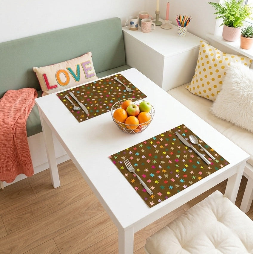 Brown paper placemat with colorful stars on a table set for a dinner. 